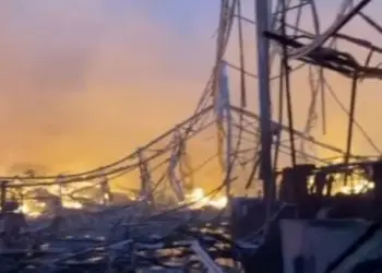 Kimberly-Clark warehouse fire destruction — collapsed structure and flames at the Ontario, California distribution center