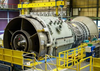 Siemens Energy SGT5-9000HL gas turbine on an assembly stand in a factory hall beneath an overhead crane