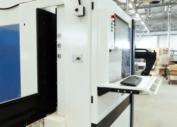 CNC machining center with control screen on a clean manufacturing floor