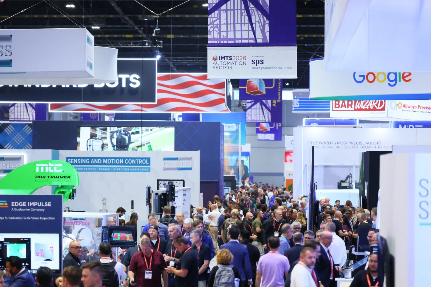 Crowded aisle at IMTS 2026 in Chicago beneath the show's Automation Sector banner, with exhibitor booths on both sides